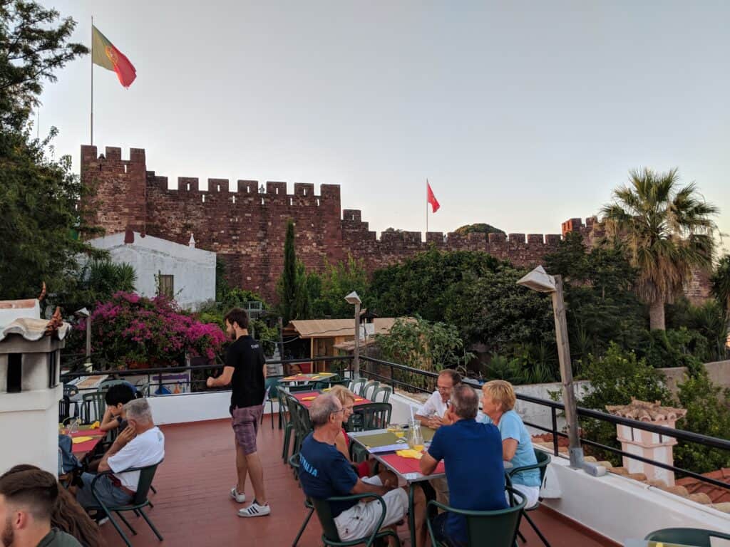 People in a restaurant see the castle